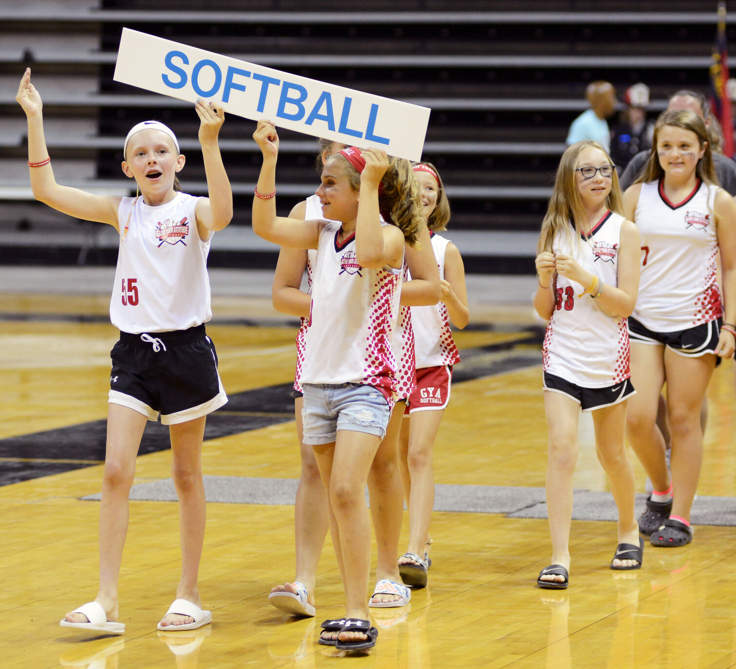 The Glove Your Attitude softball team walks onto the court